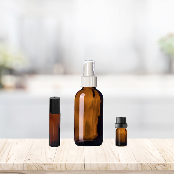 Relative sizes of our product containers. From Left to right: 10ml Amber Glass roll on bottle; 4oz Amber Glass Spray Bottle with White Fine Mist Sprayer; 5ml Amber Glass vial with black Euro dropper cap.